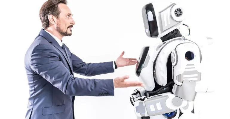 a human greeting an android robot