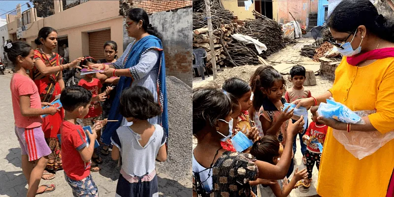बच्चों को स्टेशनरी और मास्क वितरित करते उमा