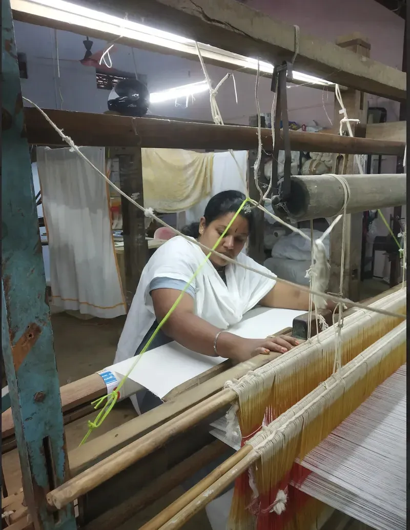 Kalaiyarasi working on a loom