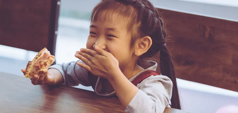 Kid eating pizza