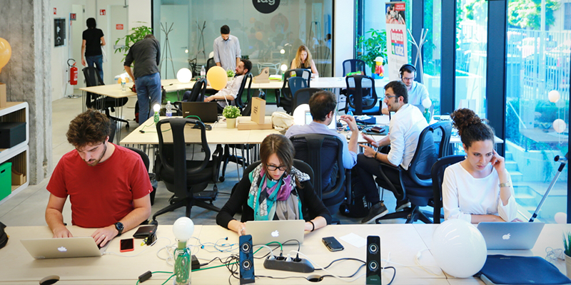 Why are larger companies now opting for coworking spaces?