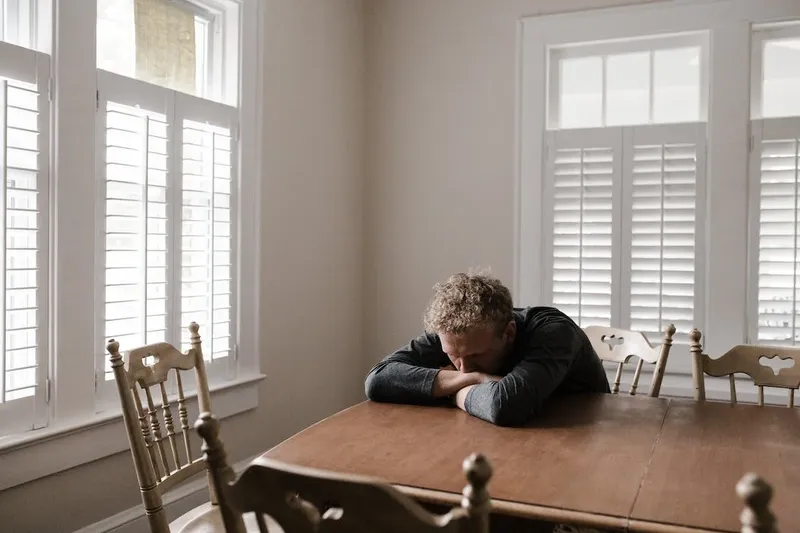 a man sitting all lonely and stressed