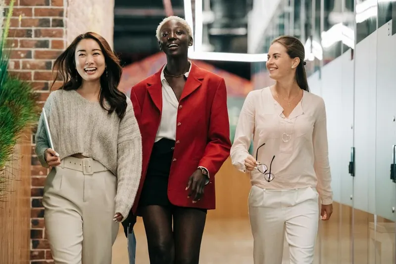 three GenZ entrepreneurs of different race walking confidently