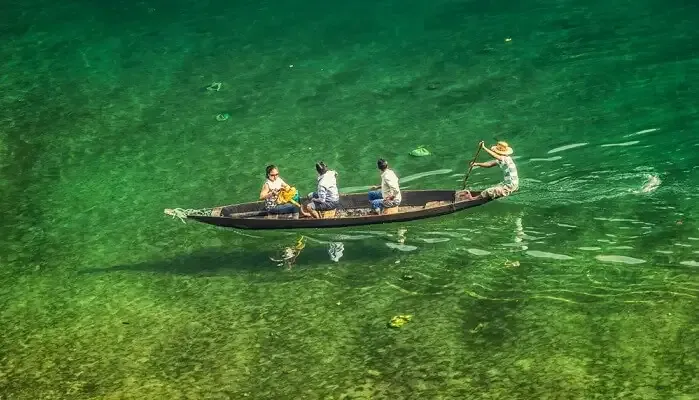 four people boating across Dawki