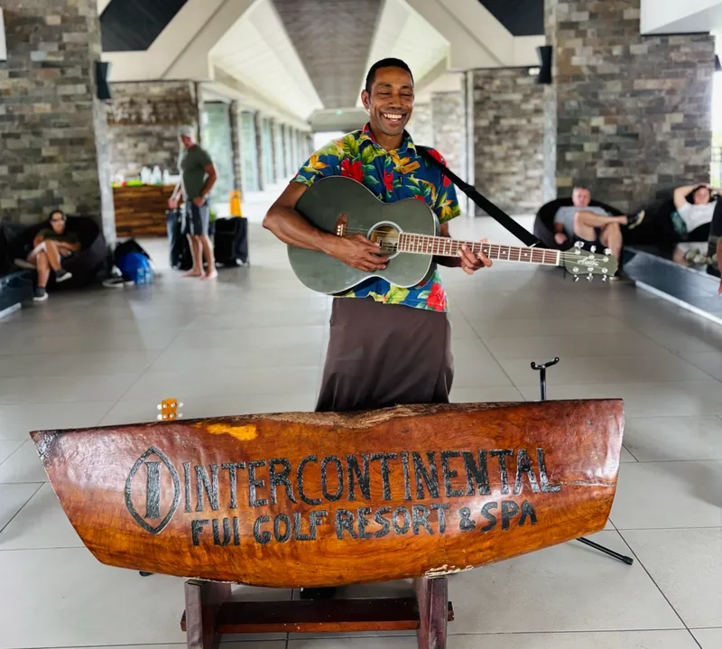 Resort staff in crisp bula shirts greeting guests