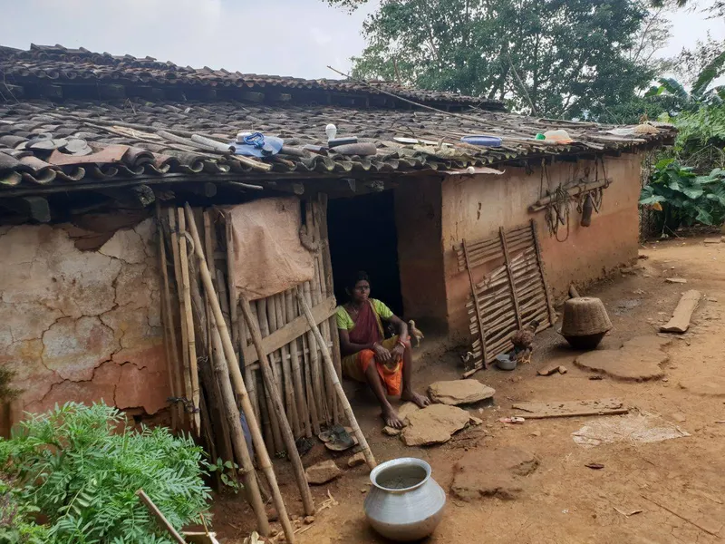 A Sabar woman sitting in her hut in Jharkhand
