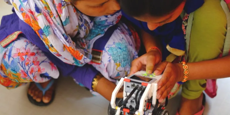 Students operating robots during a STEM class at the Community Centre