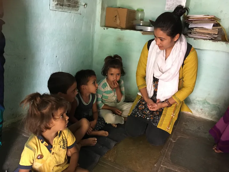 A Swasth Bharat Prerak seen interacting with young children