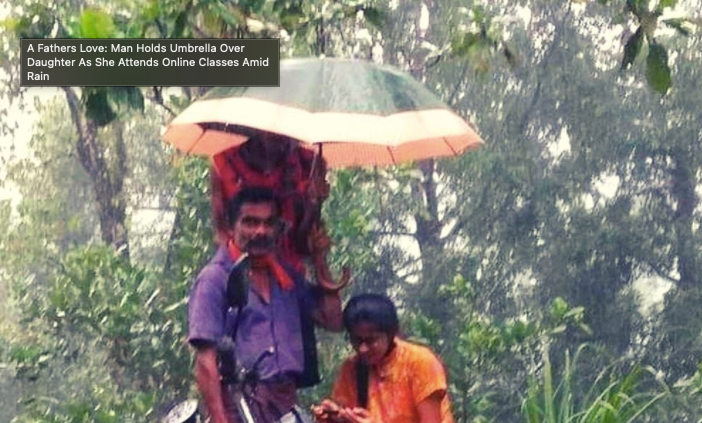Father holds umbrella as daughter attends online class on the footpath amid heavy rains
