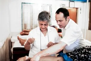 Walter with on of Barefoot's acupuncturists treating a patient