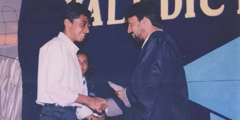 Harsha receiving award for scoring 100/100 in most subjects