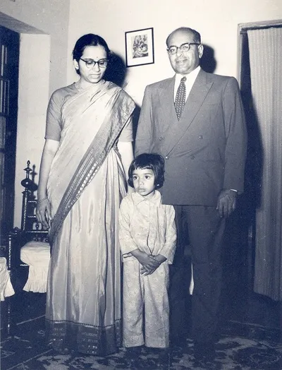 Kiran with her parents as a child