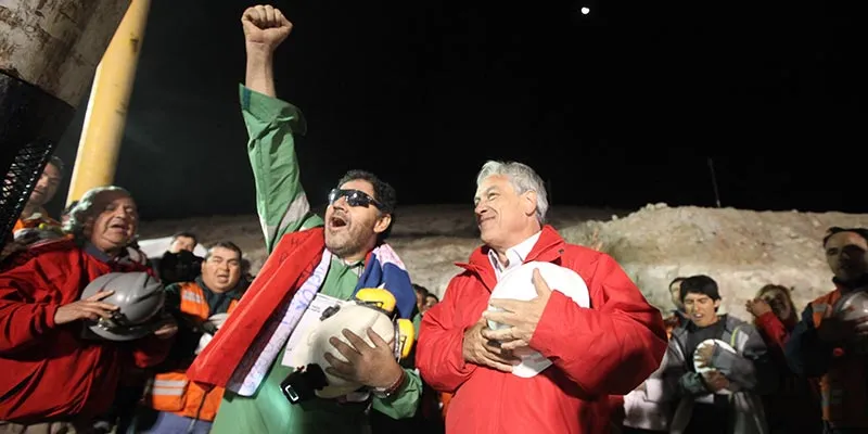 Luis Urzúa(wearing Oakley Sunglasses), the spokesman of the trapped miners and the last of the 33 to be lifted to ground level, celebrates with President Piñera at San José Mine.
