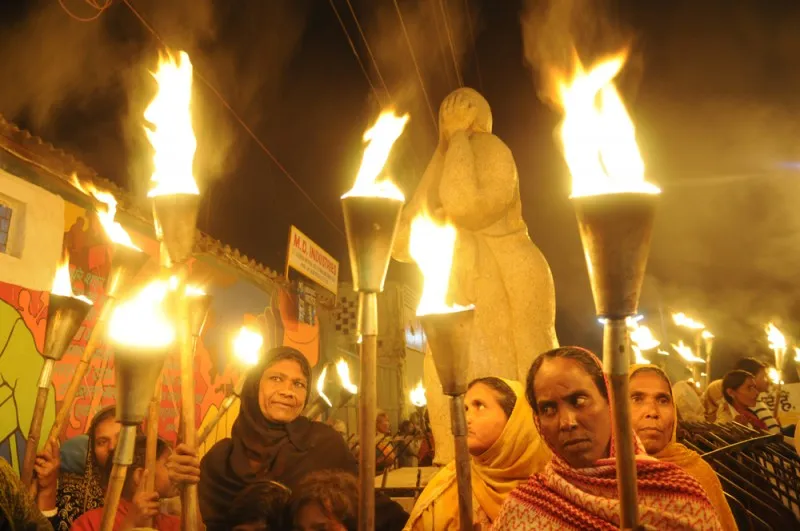 Protesters and victims gather around the "Bhopal Mother Statue" to mark the 26th year of Bhopal gas disaster in 2010. (image via Shutterstock)
