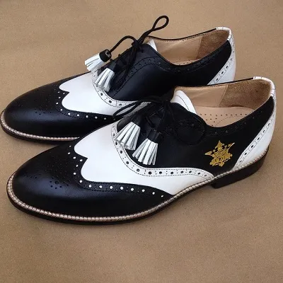 "Spectators with Tassel Laces made specially for a client with his personal logo on the shoe. "