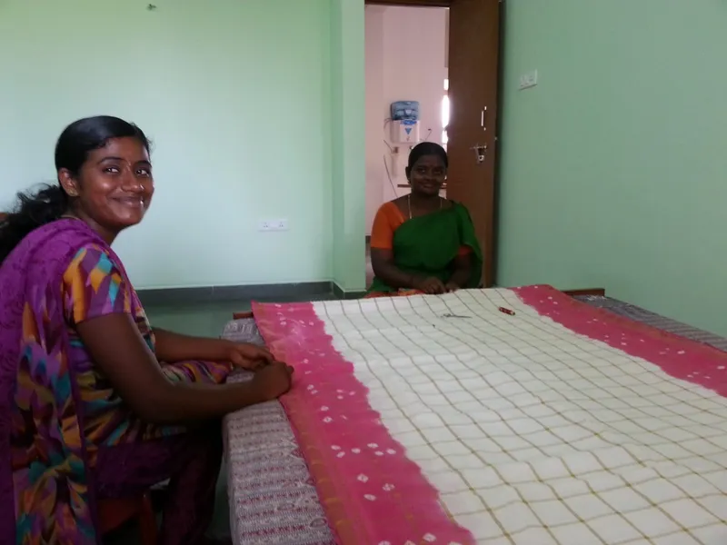 Maheshwari and Kavita working on a quilt