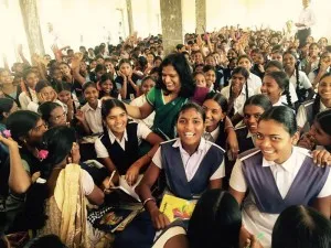 Jyothi with school children at a school function.