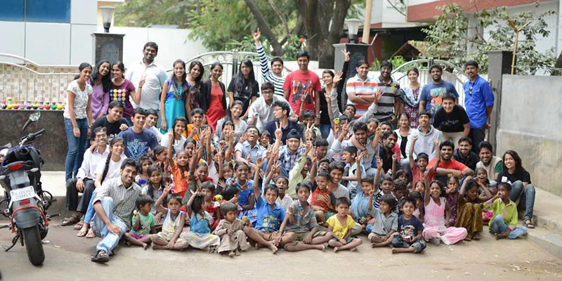 Student volunteers of Kadam with children on their footpath school.