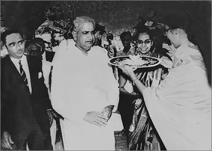 Shows the then Governor of Karnataka Mohanlal Sukhadia being welcomed to the inauguration of a charitable clinic started by Dr. Bhateja & her husband 
