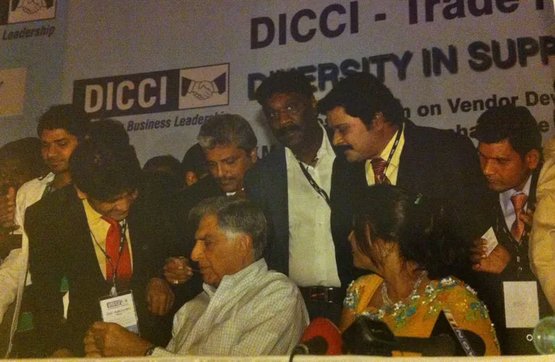 Raja Nayak (standing behind Ratan Tata) at a DICCI event in Mumbai in 2011.