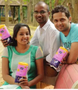 A team member flanked by Sahana Bhat (left), and Dilip Pattubala (right)