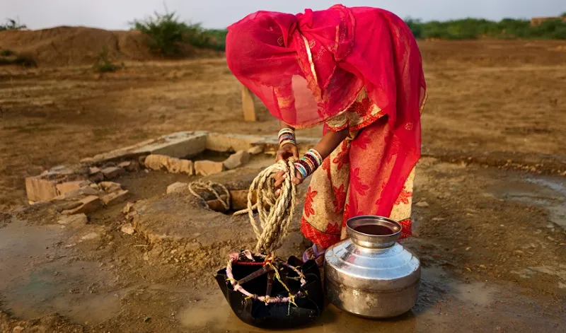 A woman carrying water to the village, Thar Desert, Rajasthan, India; Image: Getty Images