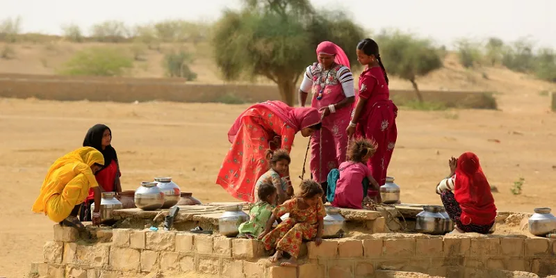 Unidentified women draw water from the well in the parched lands of Jaisalmer 