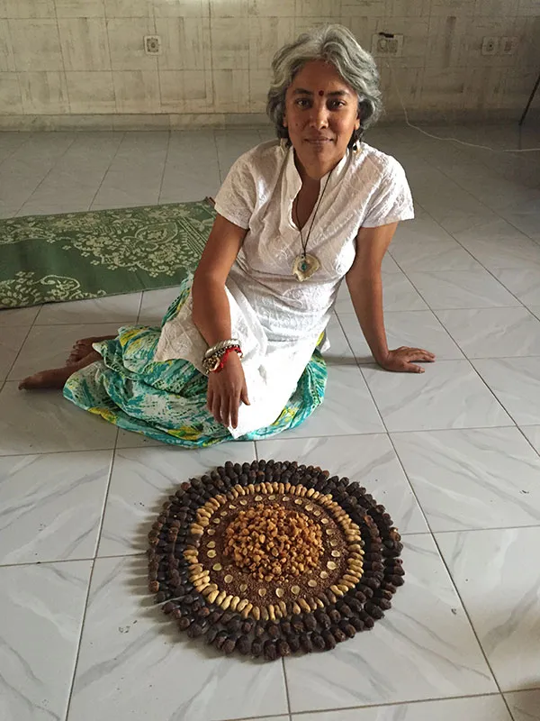 Aparna Pallavi with a wild food art installation she made. The centre of the piece is made of mahua.