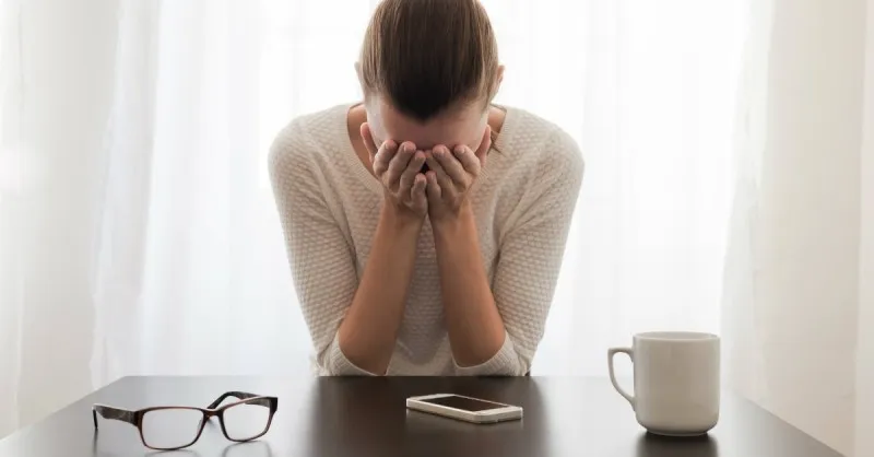 worry-stress-woman-anxiety-glasses-coffee-morning-window-light-text-phone-sad-grief