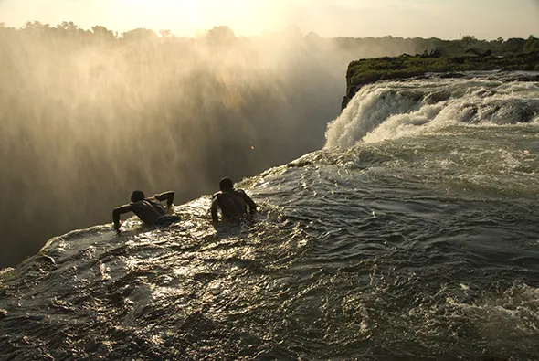 Bathing in a swimming hole at the top of Victoria Falls.