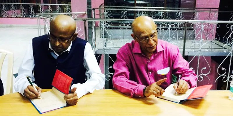 Gopalan and Ashok Soota signing copies of the book.