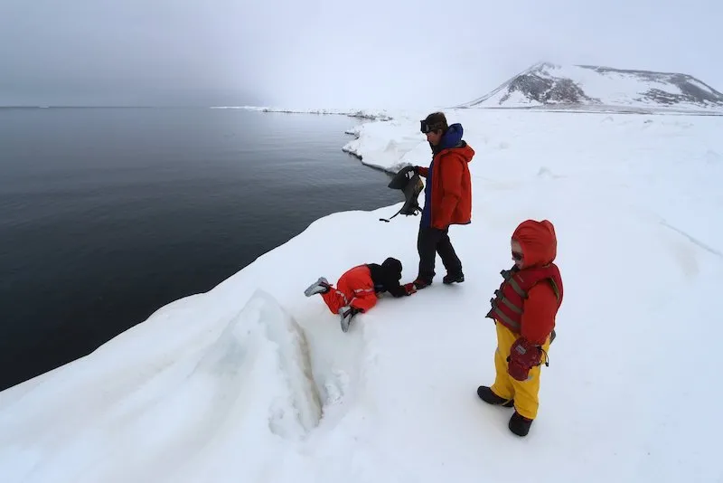 Open water absorbs sunlight, leading to dark skies over the polynya. Bretwood with his kids