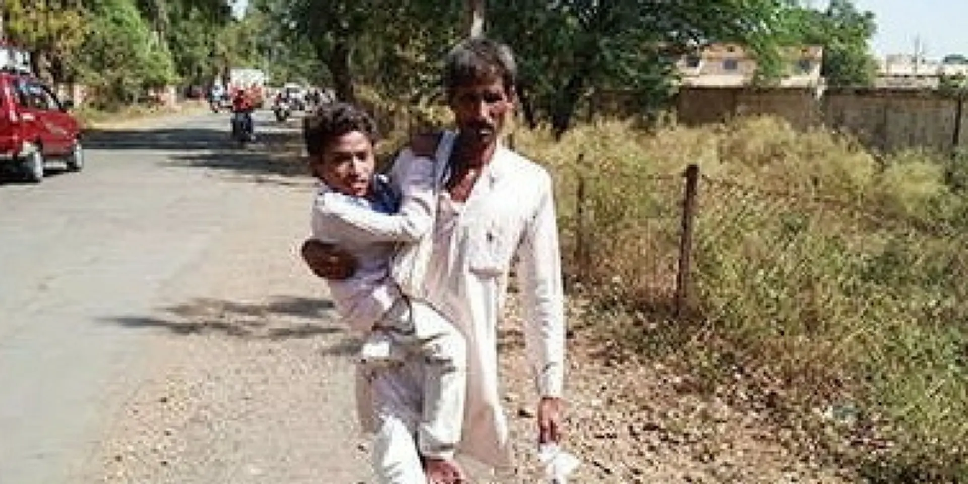 Father carries disabled son to college to ensure there is no break in education