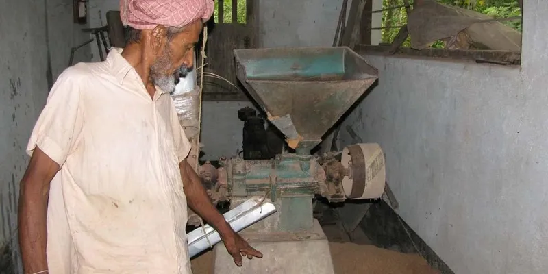 Deva Rao with his 40-year-old Huller (a diesel run machine used to separate the husk from the rice).  Parts of the  Huller are 70 years old.