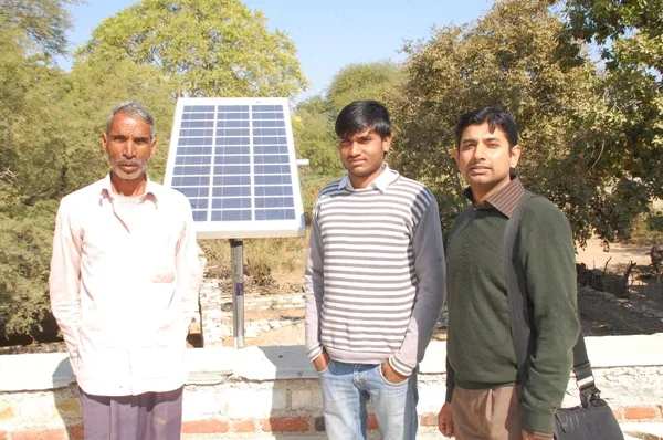 Rustam Sengupta (right), founder and CEO of Boonc, with a rural villager after a solar panel’s installation