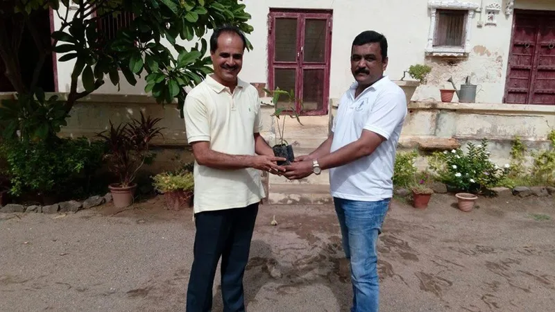 Gifting Plant sapling to Thakore Saheb Krutarthsinhji Jadeja of Devpur (Yax) on installation of Solar Water heater & Solar LED Street Light.